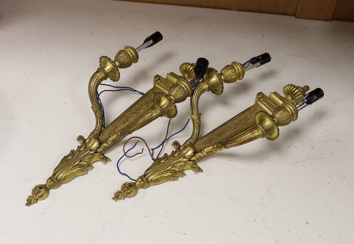 A pair of Adam style neoclassical brass wall sconces, 42.5cm